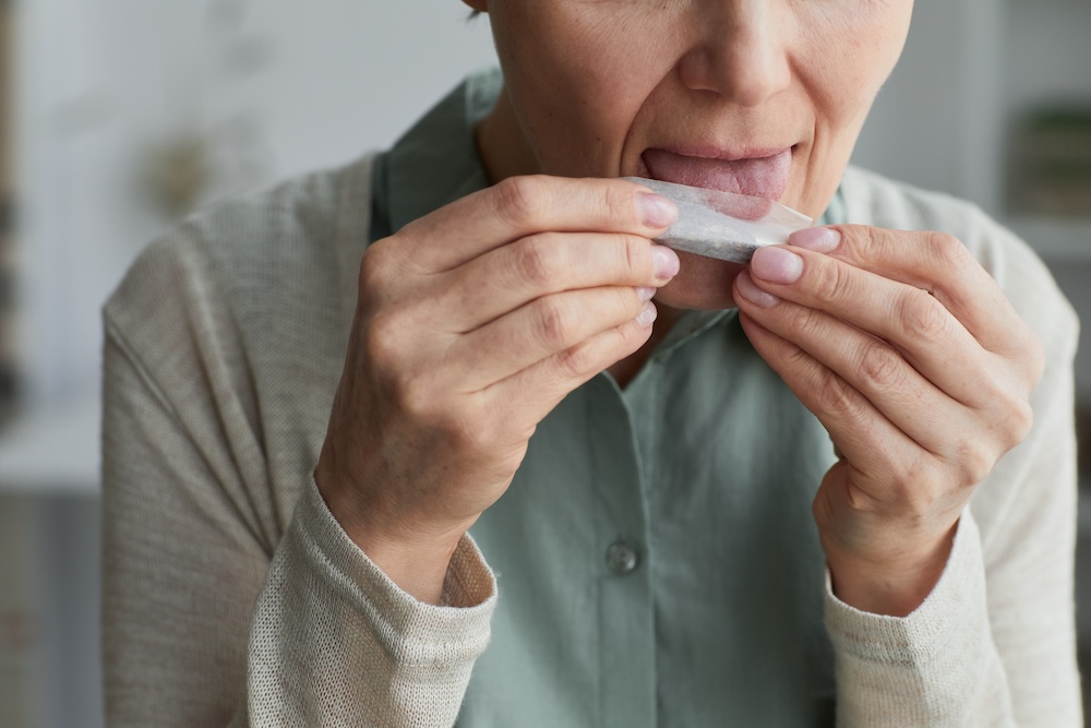 a woman rolling a weed cigaret