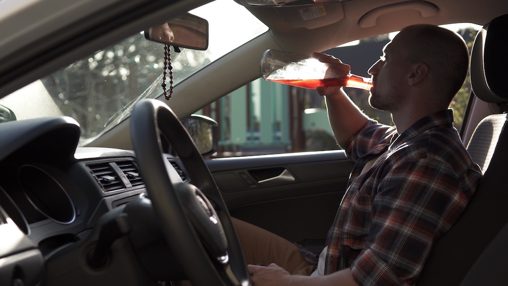 a man drinking and driving