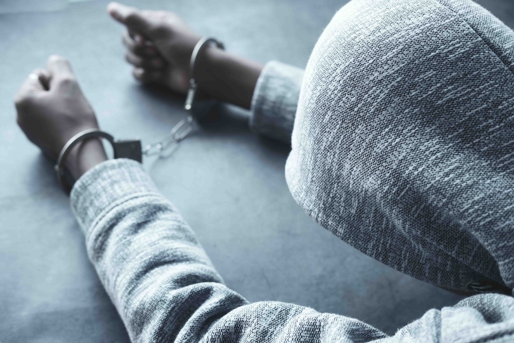 a teenager in handcuffs